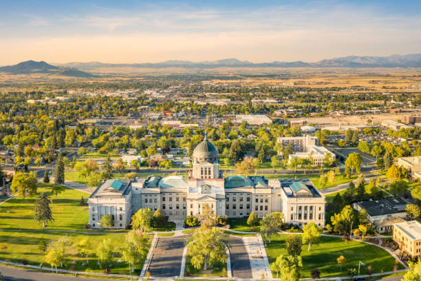 Montana State Capitol, in Helena, on a sunny and hazy afternoon. Drone view of the Montana State Capitol, in Helena, on a sunny afternoon with hazy sky caused by wildfires. The Montana State Capitol houses the Montana State Legislature. montana western usa photos stock pictures, royalty-free photos & images
