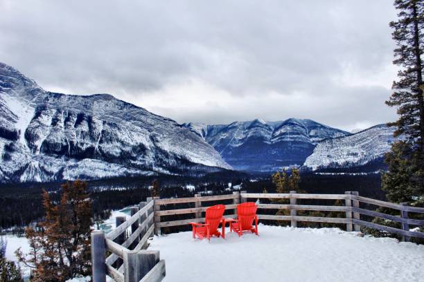 istock Snowy mountain view with two red chairs in Banff National Park 1361968793