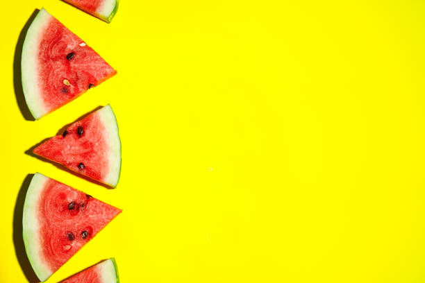 istock Watermelon slices on yellow background, flat lay. Space for text 1361968995