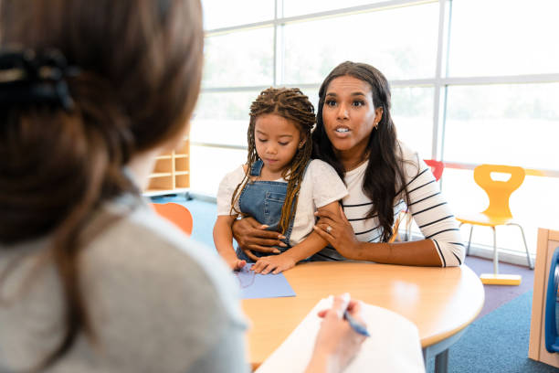 Mother emphatically defends daughter in meeting with daycare director The mid adult mother emphatically defends her preschool age daughter in a meeting with the unrecognizable female daycare director. primary school assembly stock pictures, royalty-free photos & images