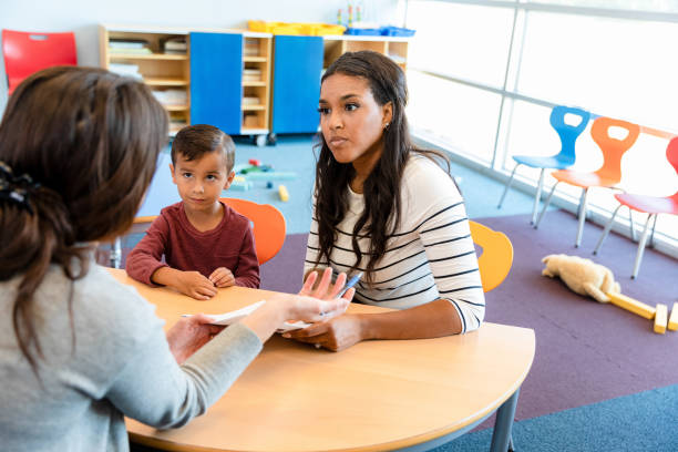 istock Angry mother listens during parent-teacher conference 1361969307