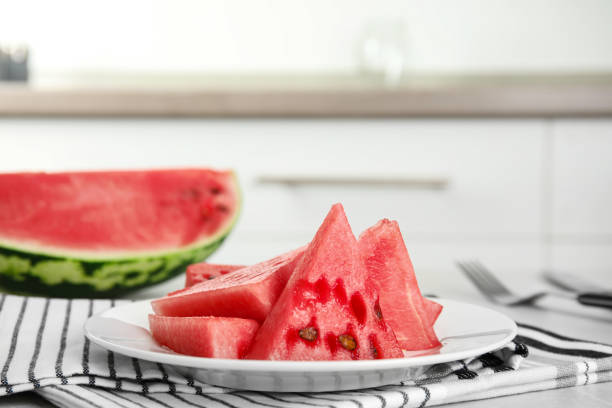 istock Yummy cut watermelon on table in kitchen, closeup 1361971782