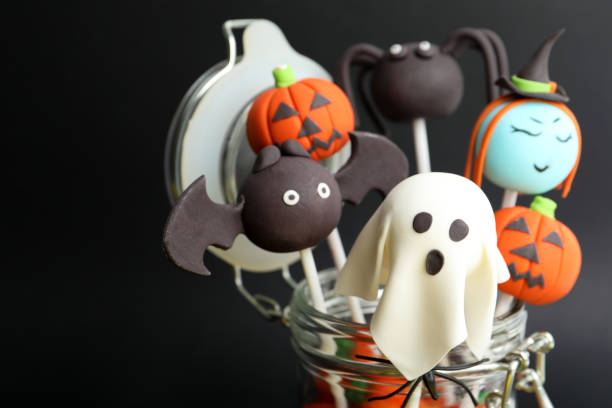 istock Delicious Halloween themed cake pops on black background, closeup 1361975000