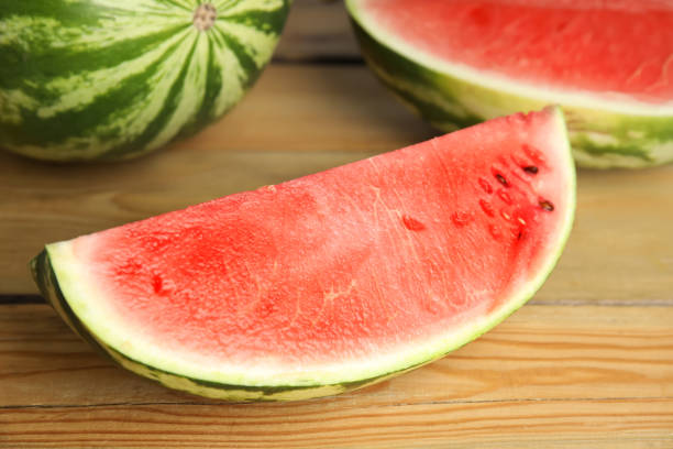 istock Yummy watermelon slice on wooden table, closeup 1361975221