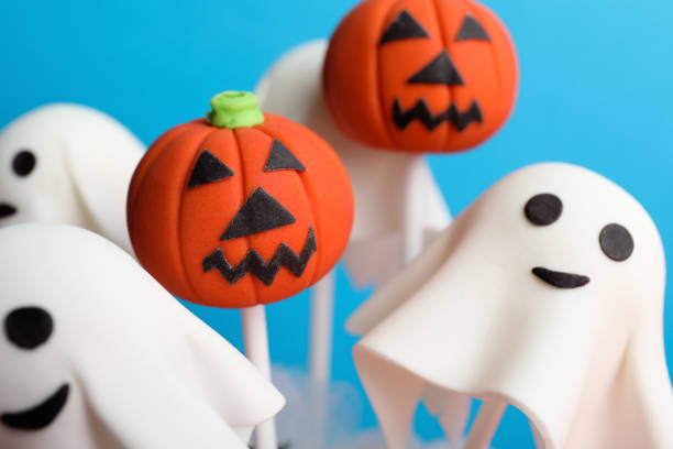 istock Delicious Halloween themed cake pops on light blue background, closeup 1361975304