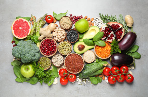 istock Different vegetables, seeds and fruits on grey table, flat lay. Healthy diet 1361978782