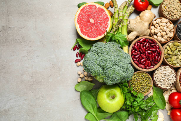 istock Flat lay composition with different vegetables, seeds and fruits on grey table, space for text. Healthy diet 1361979364