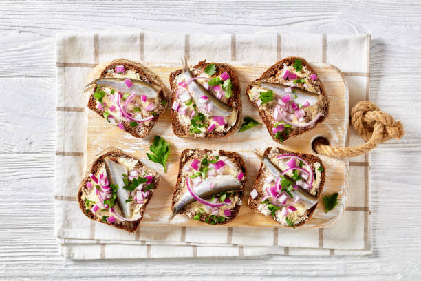 istock pickled sprat rye bread open sandwiches, top view 1361979417