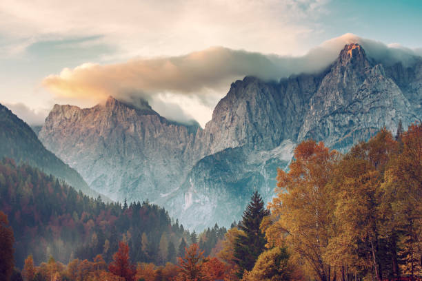Triglav mountain peak at sunrise Triglav mountain peak at sunrise with beautiful clouds in morning light. Slovenia, Triglav National Park julian alps stock pictures, royalty-free photos & images