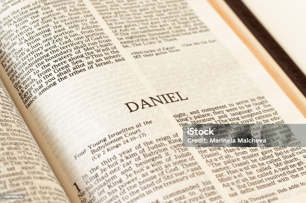 Daniel Holy Bible Book Old Testament prophet Daniel Holy Bible Old Testament prophet. Open Scripture Book inspired by God Jesus Christ. Reading and studying prophesy. A Christian biblical concept. A close-up. Book Stock Photo