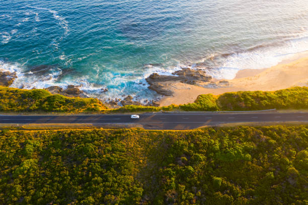 Bunurong Coastal Drive Road Aerial Aerial photograph captured along the Bunurong Coastal Drive on sunset near Gippsland, Inverloch and Cape Patterson in Victoria, Australia. drone car on road stock pictures, royalty-free photos & images