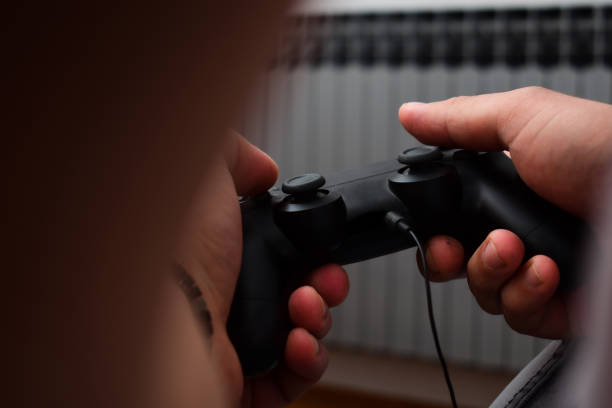 istock Mid age man playing games with the joystick after work 1362005744