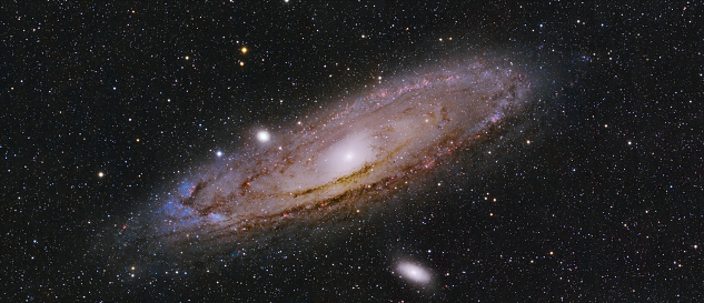 Andromeda is the nearest major galaxy to our own Milky Way Galaxy. Our galaxy is thought to look much like Andromeda. Together these two galaxies dominate the Local Group of galaxies. The diffuse light from Andromeda is caused by the hundreds of billions of stars that compose it. The several distinct stars that surround Andromeda's image are actually stars in our Galaxy that are well in front of the background object. M31 is so distant it takes about two million years for light to reach us from there.

This image was captured using amateur astrophotography equipment including a Skywatcher 80mm telescope, a QHY269M monochrome camera and a seven position filter wheel containg Red, Green, Blue, Hydrogen Alpha, Oxygen III and Sulphur II filters. Tracking was done using an iOptron CEM70G mount and PHD2 guiding software.  It was entirely processed using PixInsight.