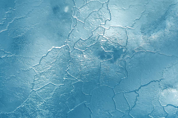 The pattern and texture of ice on a frozen river.