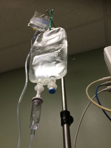 istock Bag of IV Fluid Hangs Highlighted 1362019041