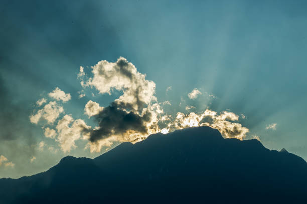 istock Sun shines behind the blue sky.Sun hiding behind a cloud on the day sky 1362021143