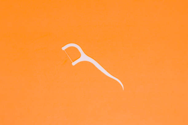 istock A White Dental Floss in The Orange Backrground with Flatlay Shot 1362021864