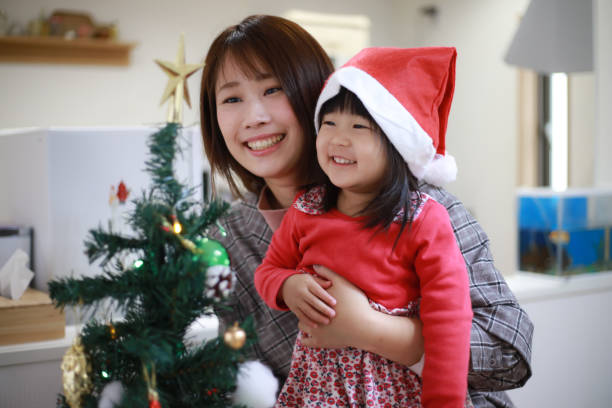 istock Parents and children decorating Christmas trees 1362021919