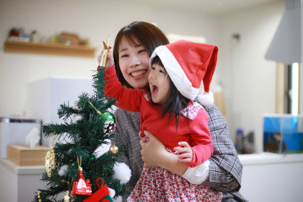 istock Parents and children decorating Christmas trees 1362021951