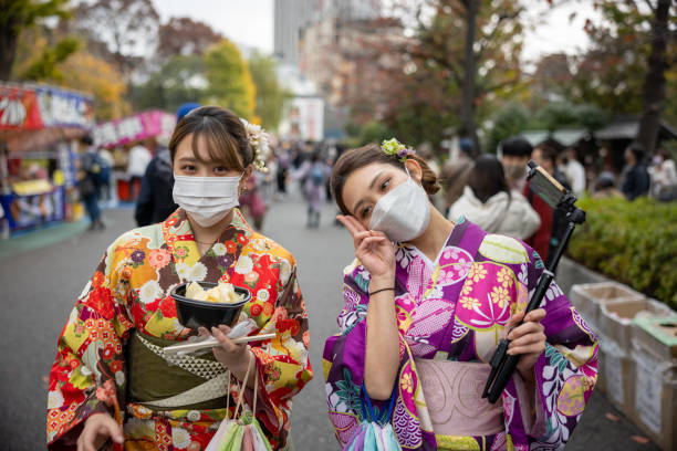 Young women in kimono walking on street stock photo