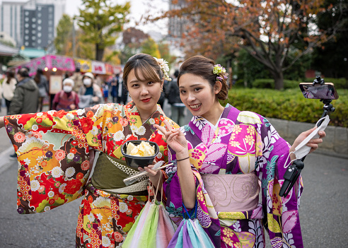 Japanese female friends in Kimono vlogging in Tokyo.