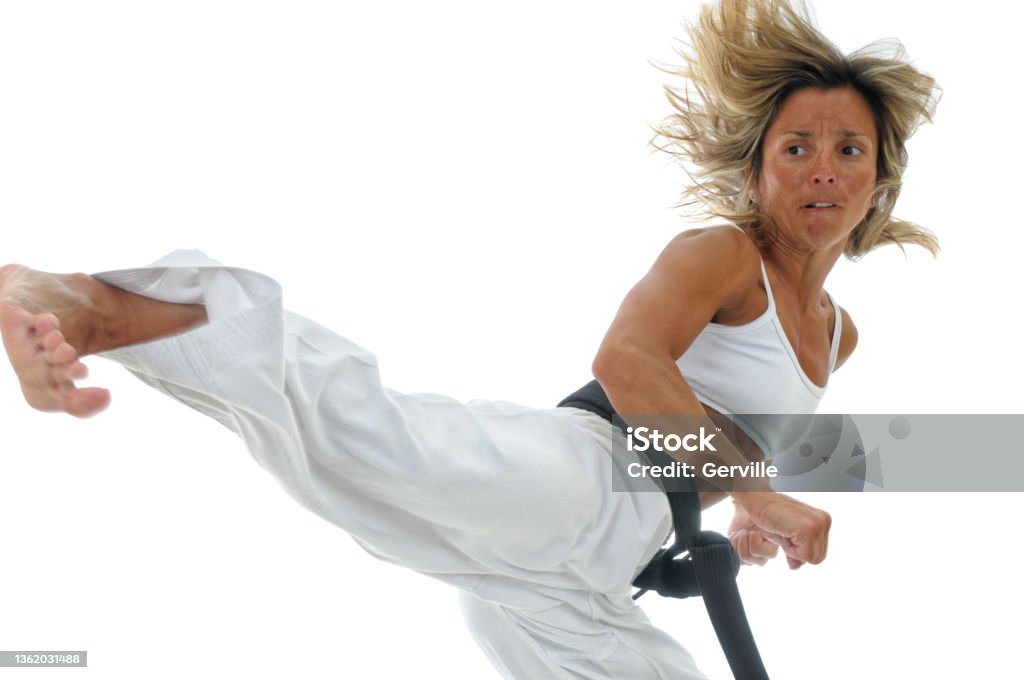 Turning Power Martial artist jumping, turning, and kicking. Martial Arts Stock Photo