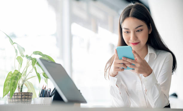 istock Asian businesswoman using smartphone sending online message 1362034244