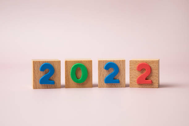 istock wooden cubes with word 2022 on pink background 1362038230