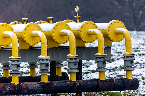 Winter photo of a snow-covered gas pipeline. High natural gas prices. The photo was taken on a cloudy day.