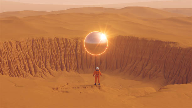 istock Orange Spaceman Spacewoman With Large Alien Silver Sphere Glowing Orange Crater Desert Sand Dune Sci Fi Astronaut Cosmonaut Landscape Bright Sun Reflection Lens Flare 1362044512