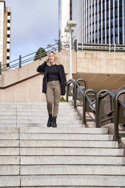 istock Woman speaking on cellphone on stairs 1362047179