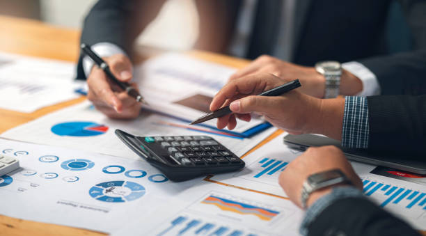 istock businessman working at office with his colleague at office, doing planning analyzing the financial report, business plan investment, finance analysis concept. 1362047674