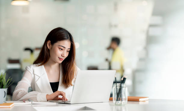istock Young female entrepreneur working on laptop computer at office. 1362048667