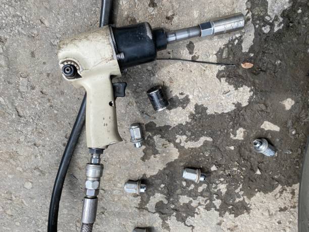 istock pneumatic gun and nuts, remove, install, replace wheel tire nut for car & vehicle service concept 1362052535