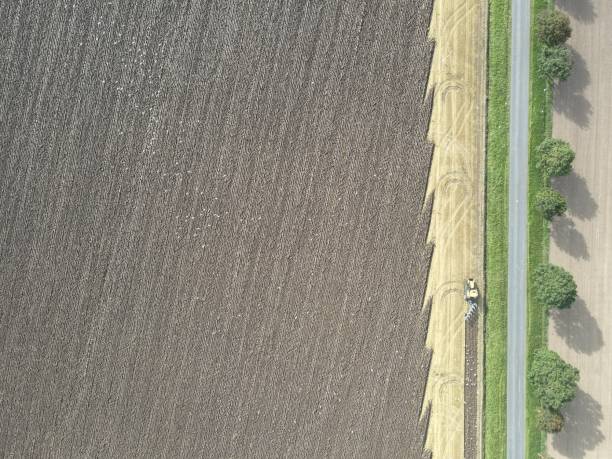 istock Looking down on a farmer ploughing his field 1362057412