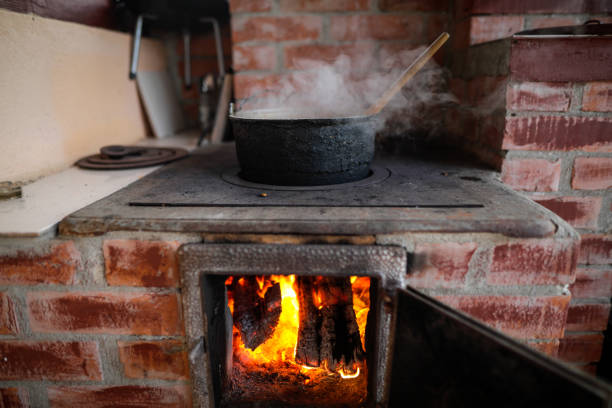 istock Cast iron cauldron boiling a goulash stew over a wood burning stove made from red bricks in the backyard of a rural house in Romania. 1362062773