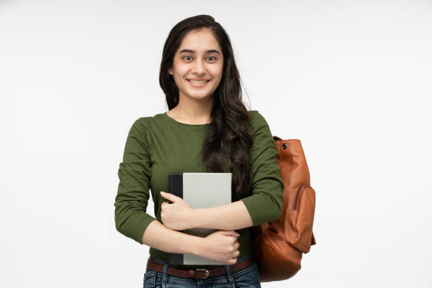 Female teen student with a backpack and books smiling stock photo Student, Teenager, Adolescence, White Background, Cut Out college students stock pictures, royalty-free photos & images