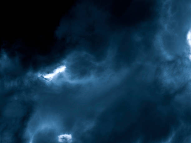 Moon shining through clouds stock photo