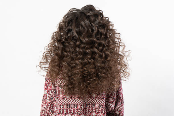 istock A woman with curly long dark hair, turned her back 1362066654