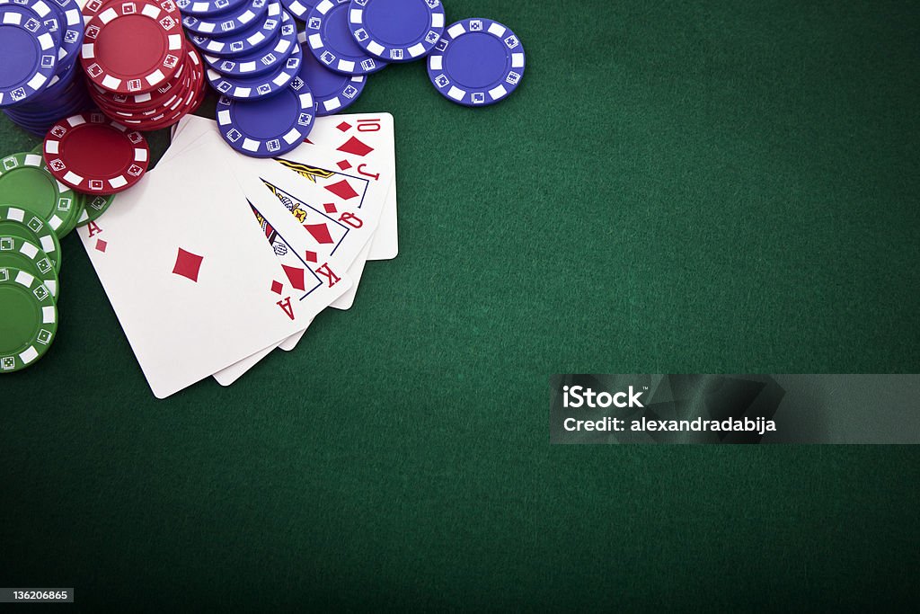 Royal flush & gambling chip Royal flush and gambling chip on a green poker table Poker - Card Game Stock Photo