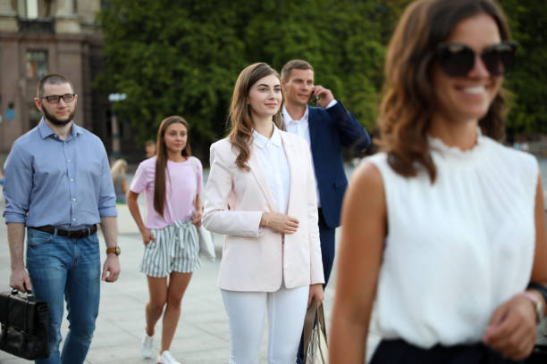 istock Different people walking on modern city street 1362068714