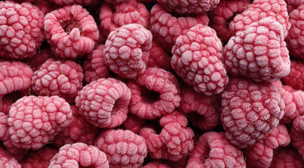 istock Tasty frozen raspberries as background, top view 1362068730