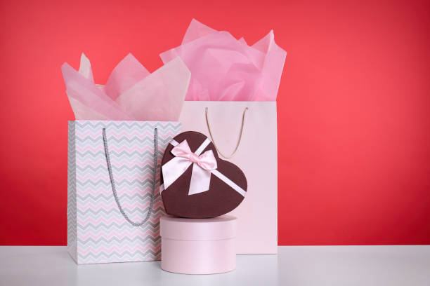 istock Shopping paper bags and gift boxes on red background. Space for text 1362070436
