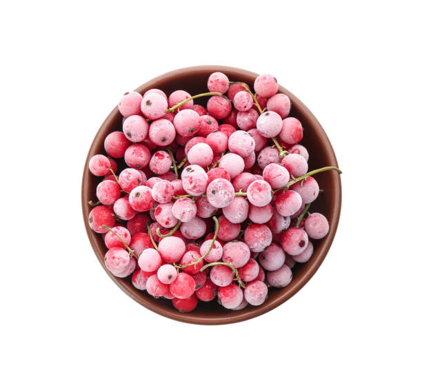 Tasty frozen red currants in bowl on white background, top view