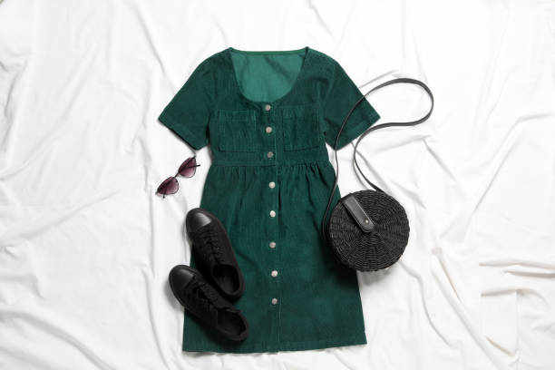 istock Flat lay composition with stylish green dress on white fabric 1362072723