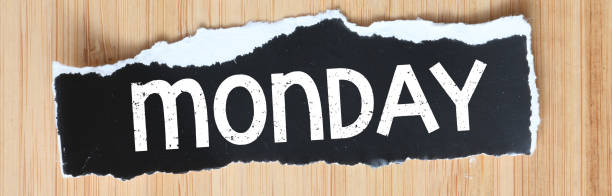 MONDAY words written on small black sheets of paper.