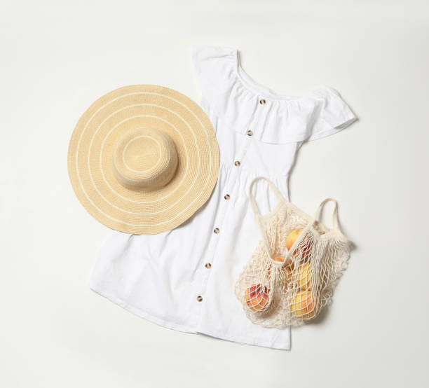 istock Stylish dress, hat and peaches on white background, flat lay 1362073468
