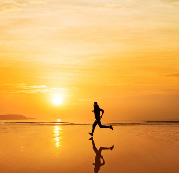 istock Man running on the golden beach 1362076324