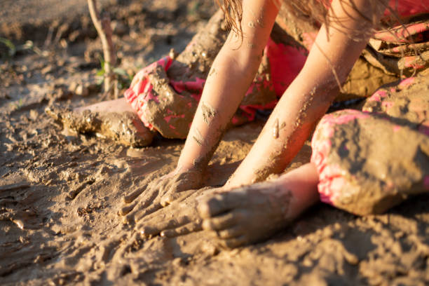 istock Little girl playing with dirt mud 1362076968