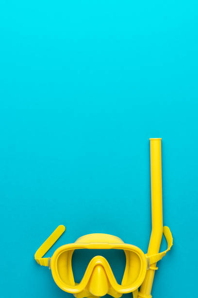 istock yellow diving mask and snorkel over blue background with copy space 1362078883
